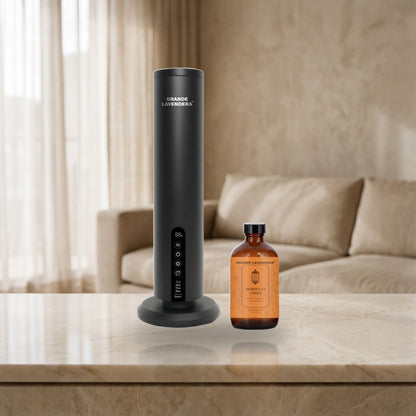 Grande Lavendera Smart App Waterless Aroma Diffuser with 4 oz Moroccan Amber diffuser oil on a marble console, introductory offer set