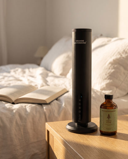 Grande Lavendera Smart App Waterless Aroma Diffuser with 4 oz Forest Floor (inspired by Baccarat Rouge 540) diffuser oil on a bedroom nightstand, introductory offer set