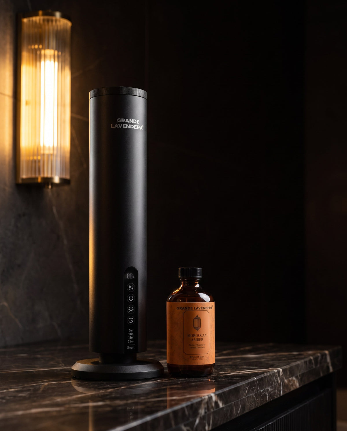 Grande Lavendera Smart App Waterless Aroma Diffuser with 4 oz Moroccan Amber diffuser oil on dark marble at night